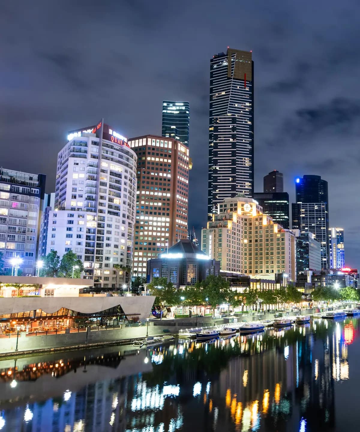 Southbank's towers lit up at night, reflected in the Yarra River